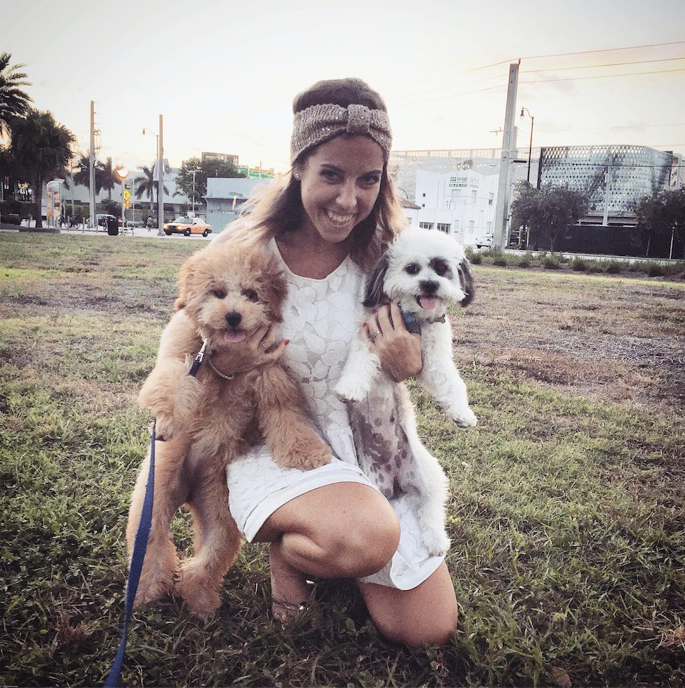 Adri CEO of The Creative's Loft with two little puppies at the park