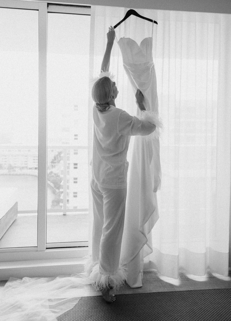 Bride hanging her dress at her suite