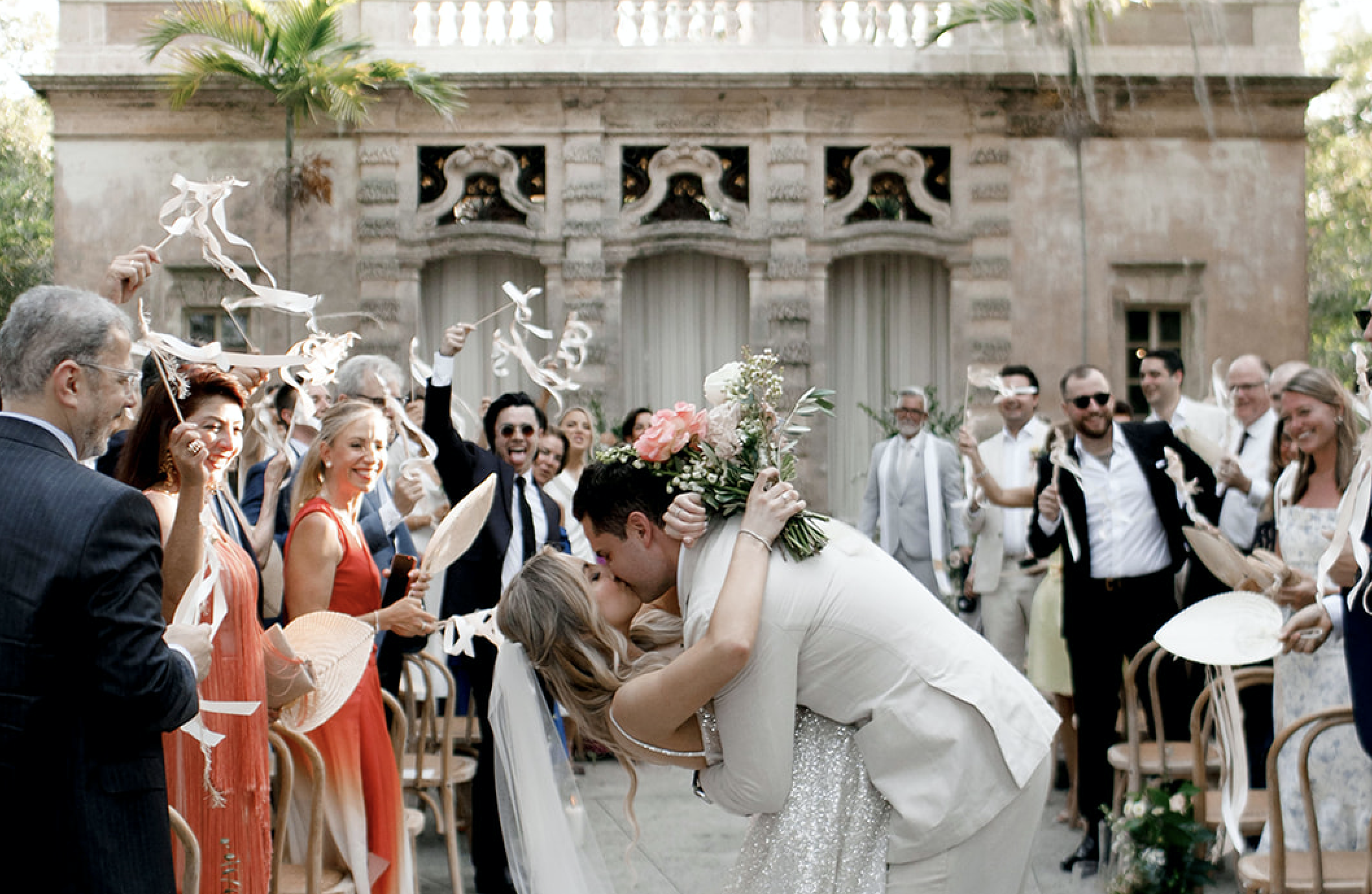 The bride and groom kissing after their ceremony at Vizcaya Museum.