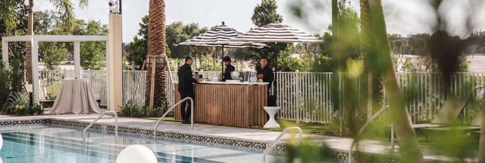 Overlooking the pool there is a bar serving drinks to guests.