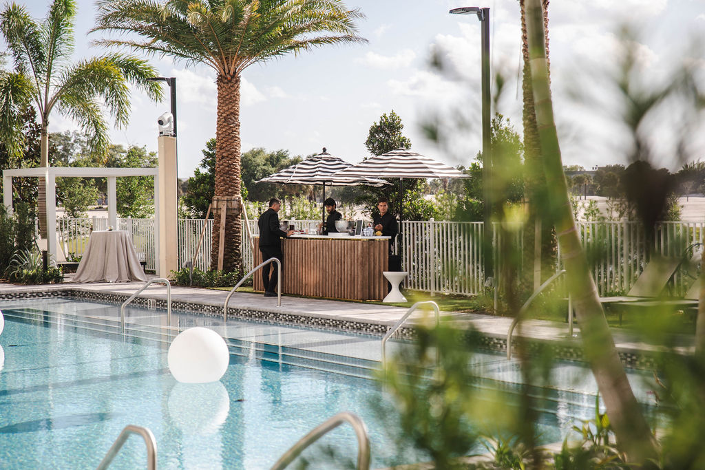 Overlooking the pool there is a bar serving drinks to guests.