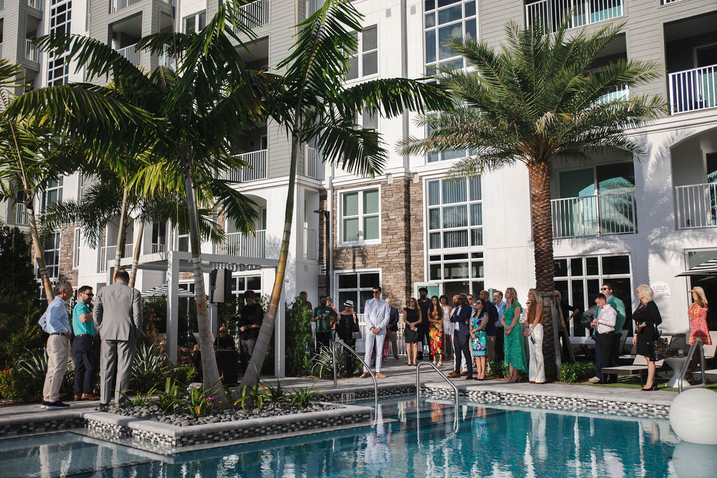 General Shot of the Pool Deck with guests around It.